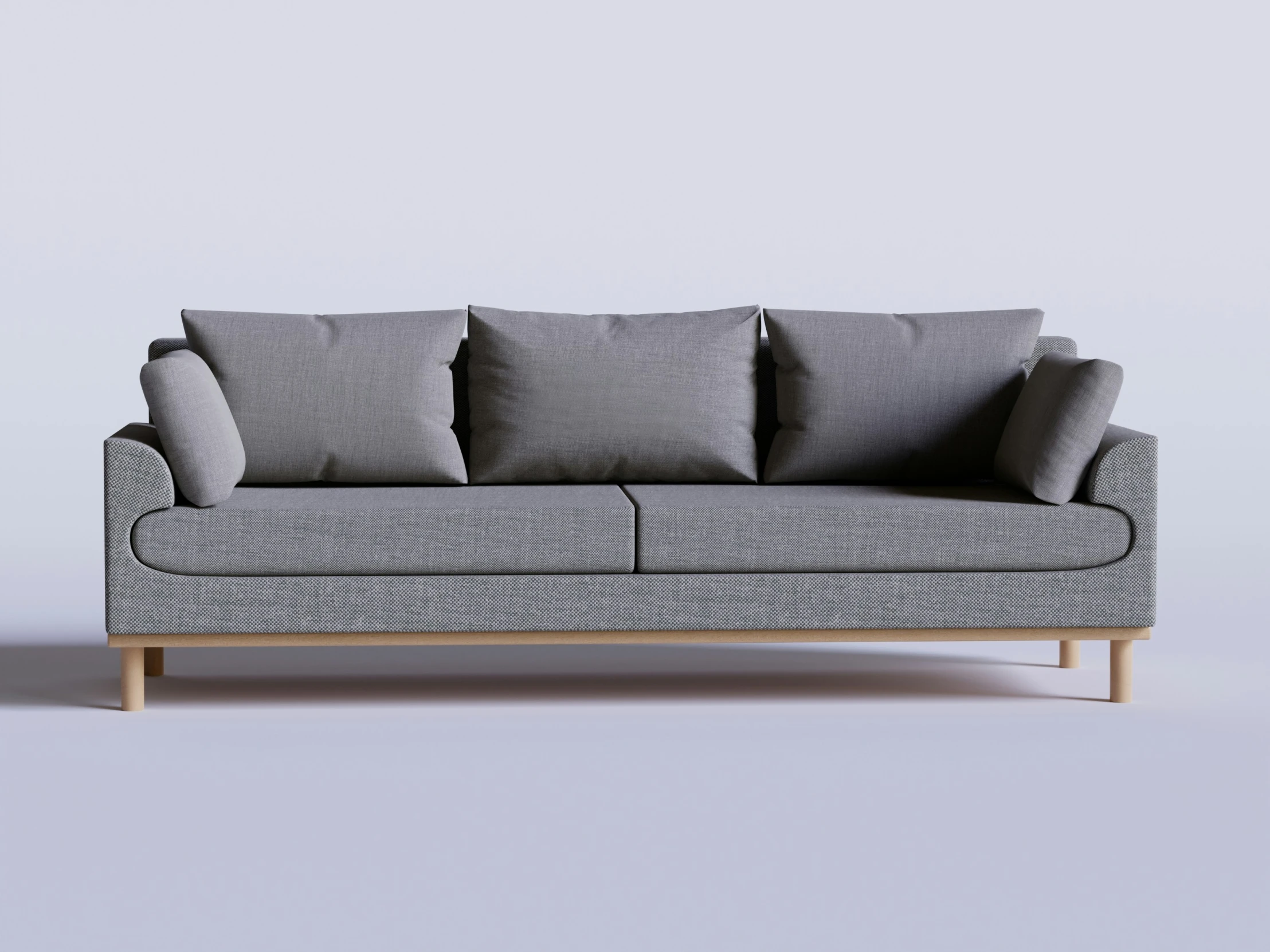 a grey couch that has pillows on it