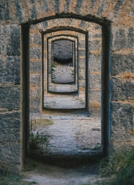 this is a stone arch with a view looking out on a brick path