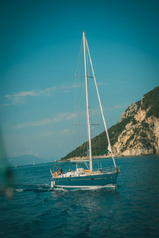 a sailboat sails through the water on a sunny day