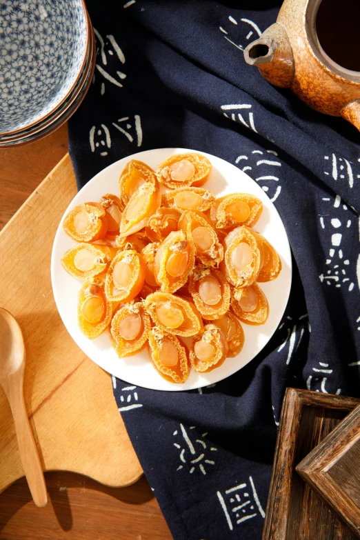 a white plate with fried oranges sitting on top of a table