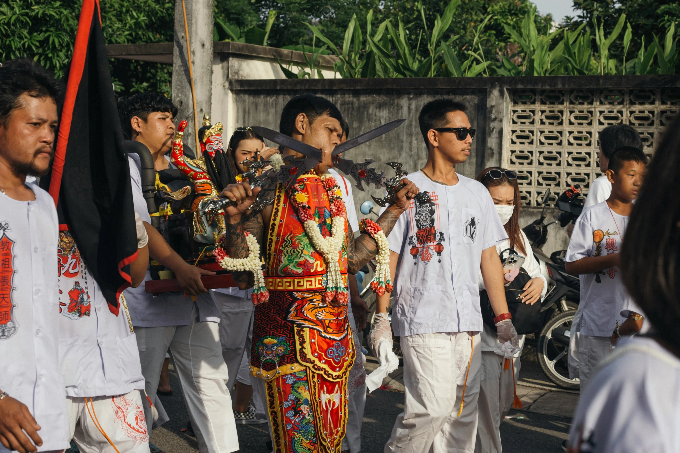 men walking through an ethnic parade with white clothing