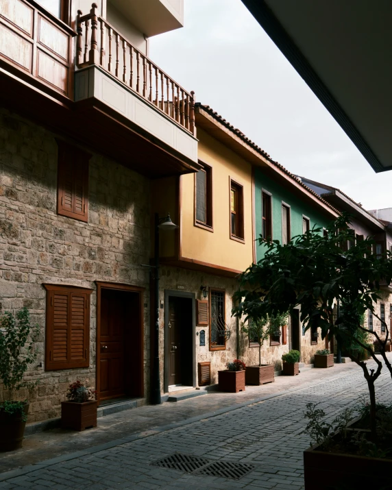 the exterior view of an apartment building with small trees in pots