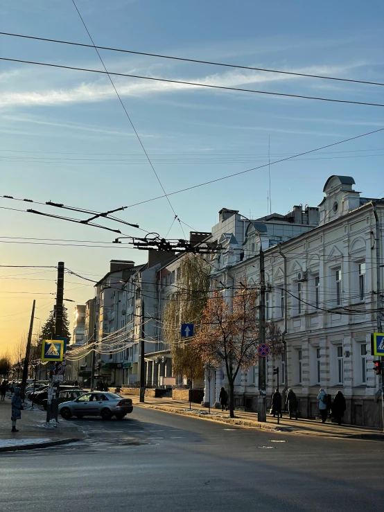 an old city street with power lines crossing