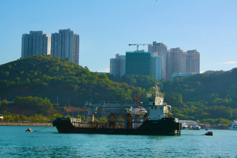 a ship on the water with a city in the background