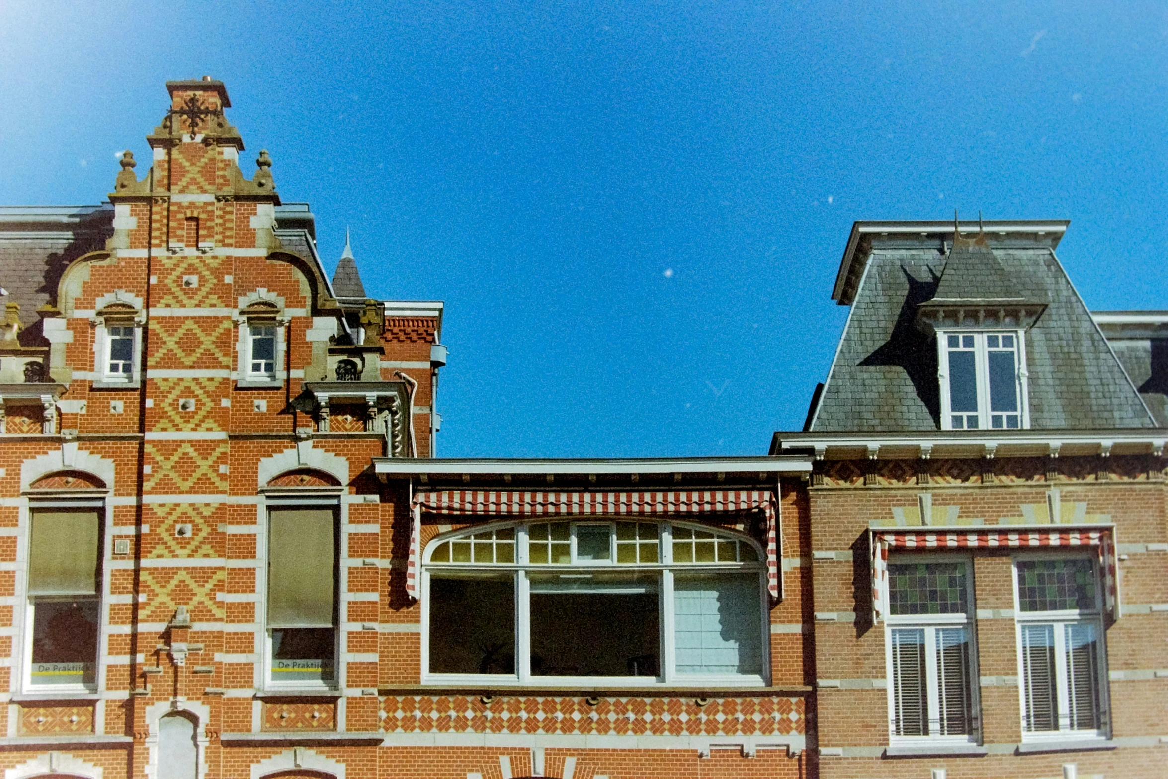 two different images of a building one with the same clock, and one with a window with a bird on it