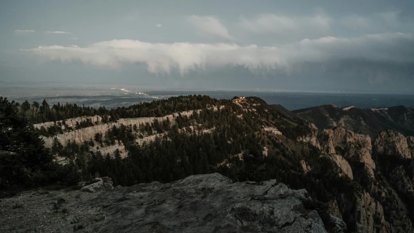 the view from a mountain top of snow covered trees