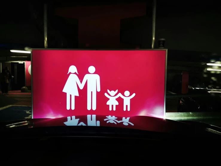 sign indicating family and children are on the display in the dark