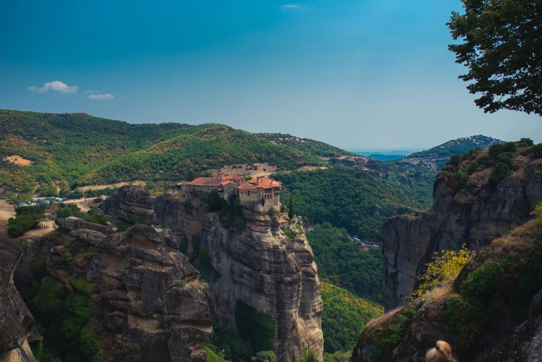 mountains and forests surrounding the rock town