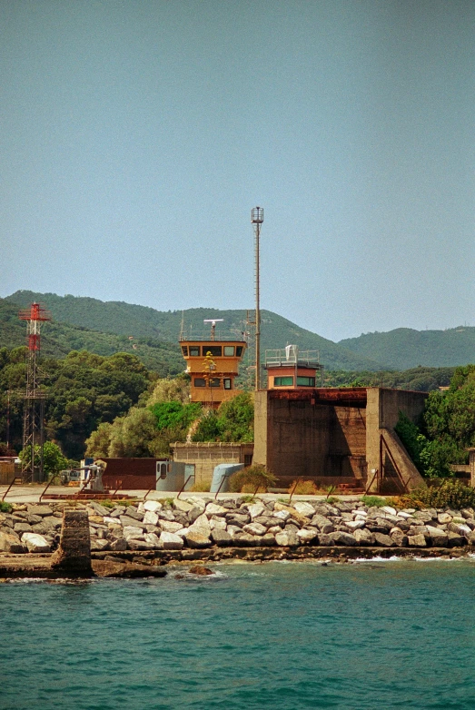 two red buoys are above a rock wall and pier