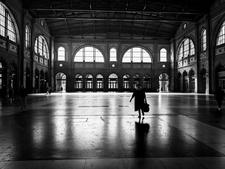 a black and white po of people walking in a train station