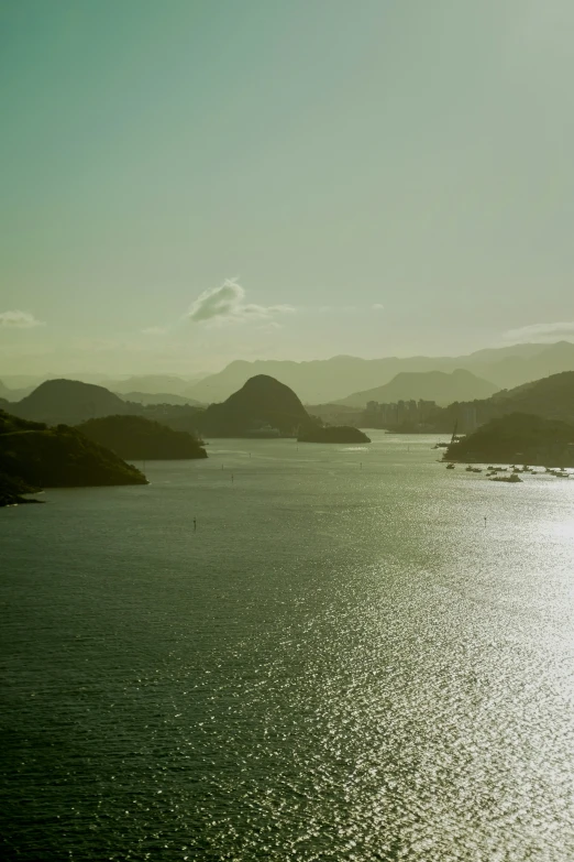 a body of water surrounded by hills and trees