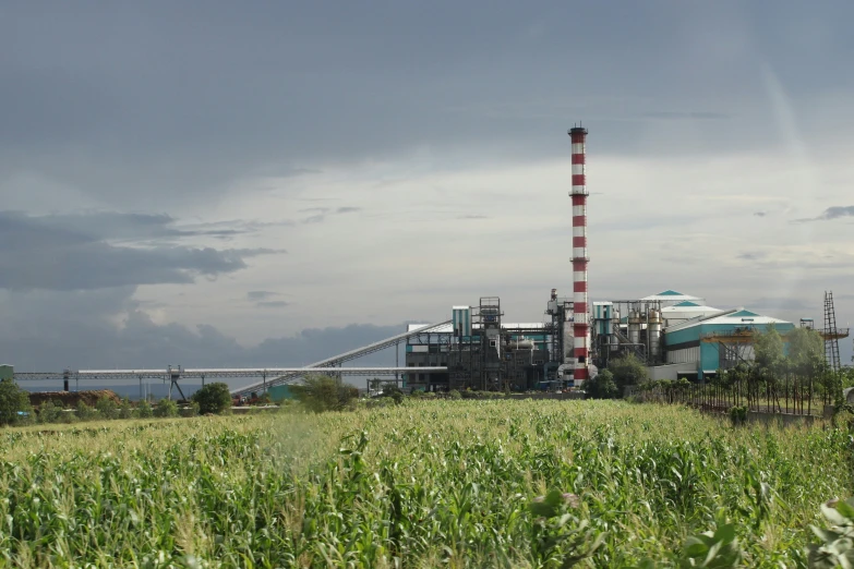 a power plant is behind an open field