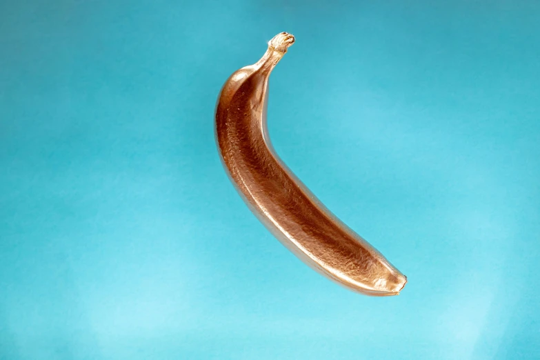 a banana shaped like a tube or soing in gold