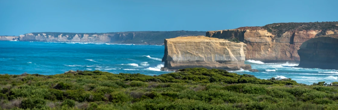 a scenic view of a ocean and cliffs