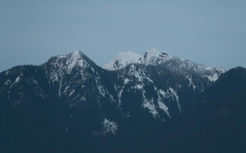 a view of mountain range with a boat in the foreground