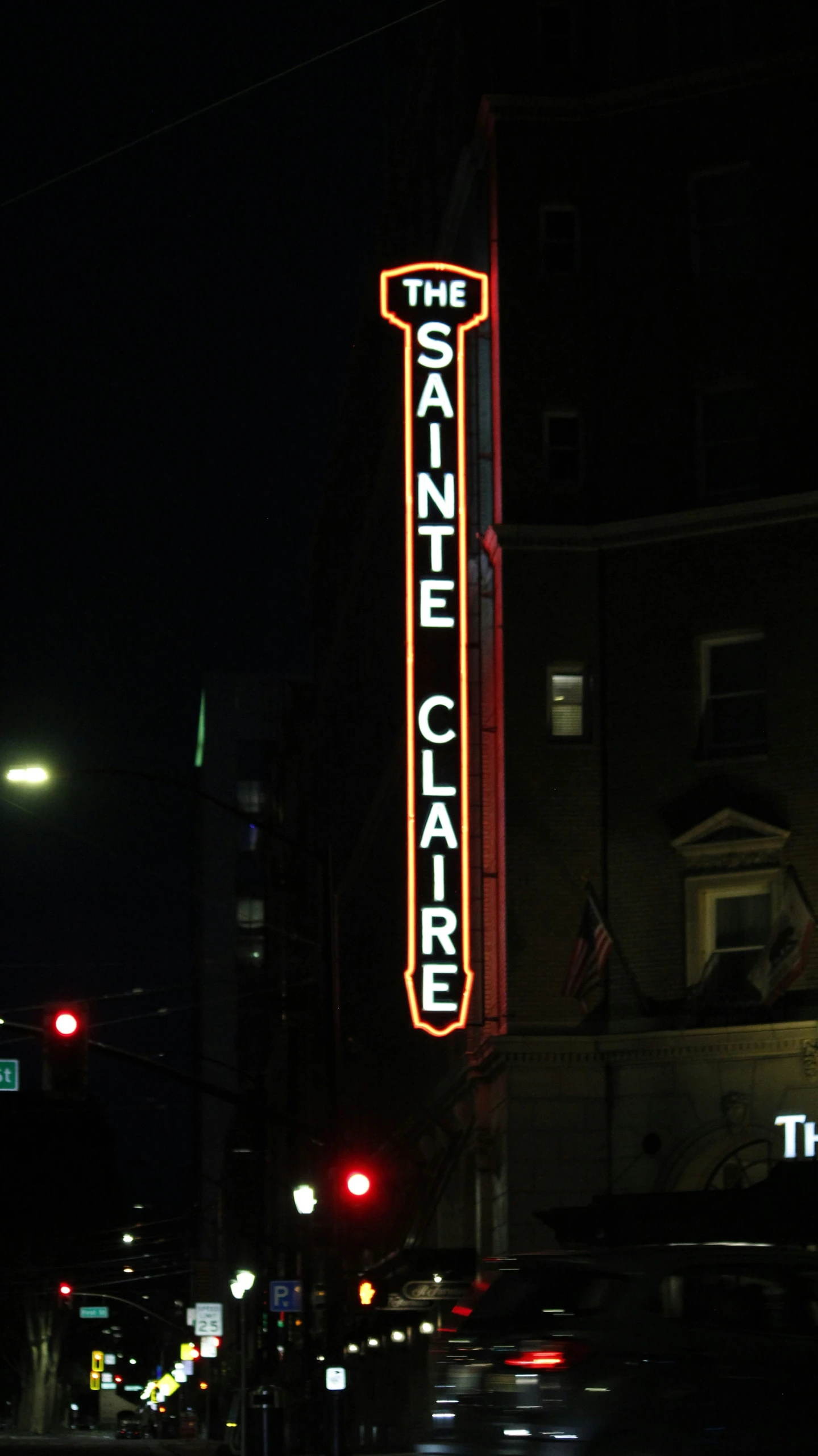 a tall building has some neon letters on it