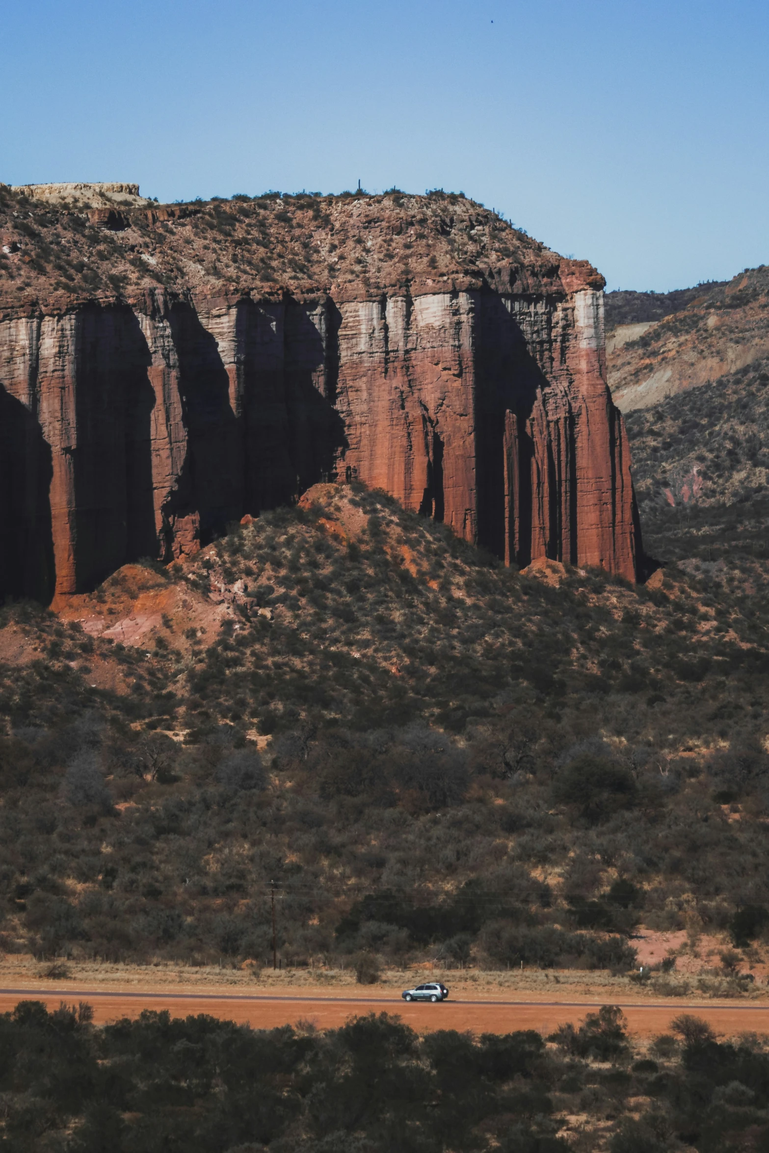 there are mountains and hills on either side of the road