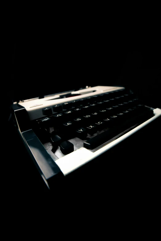 a dark image of a computer keyboard and mouse