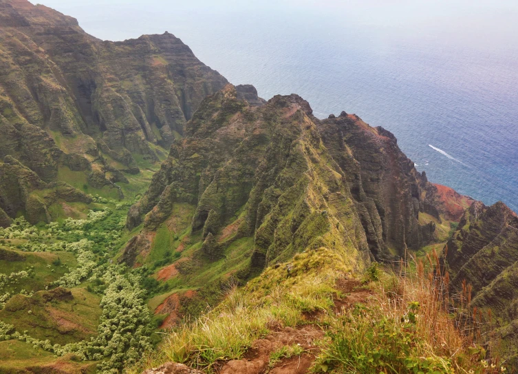 a man is on a steep hill near the ocean