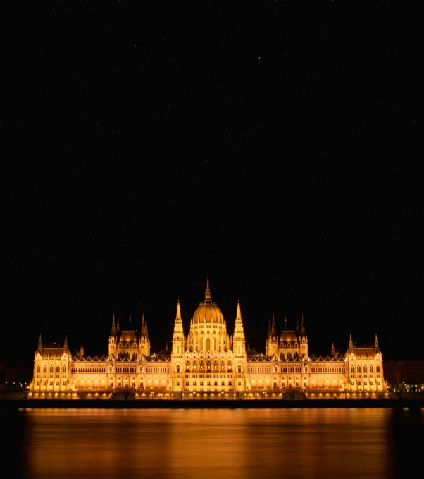 the large building is very ornate and lit up at night