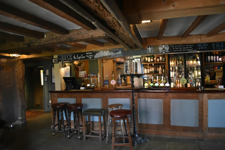 this is an old fashioned looking bar with many bottles