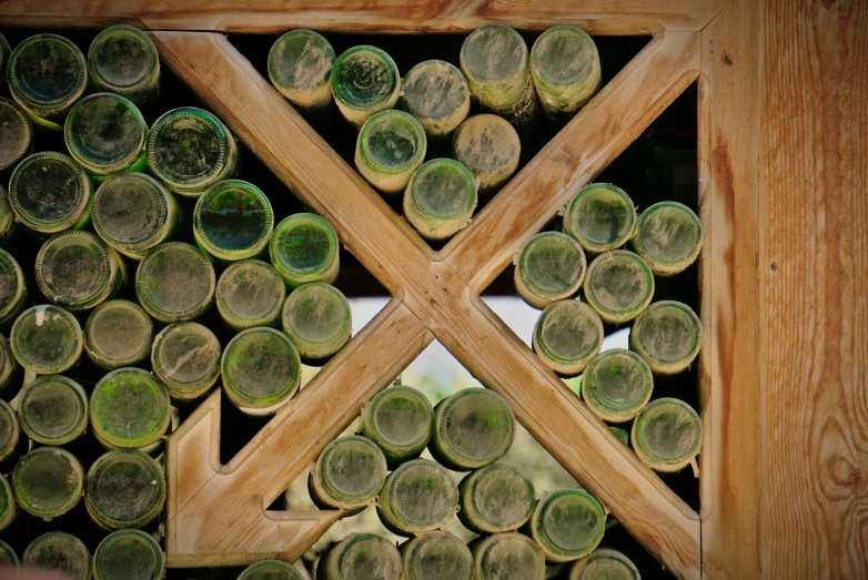 there are many bottles on the table as well as two of them are arranged around a geometric pattern