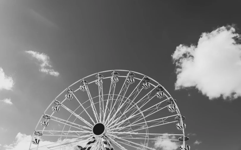 an amut wheel is standing in front of the clouds