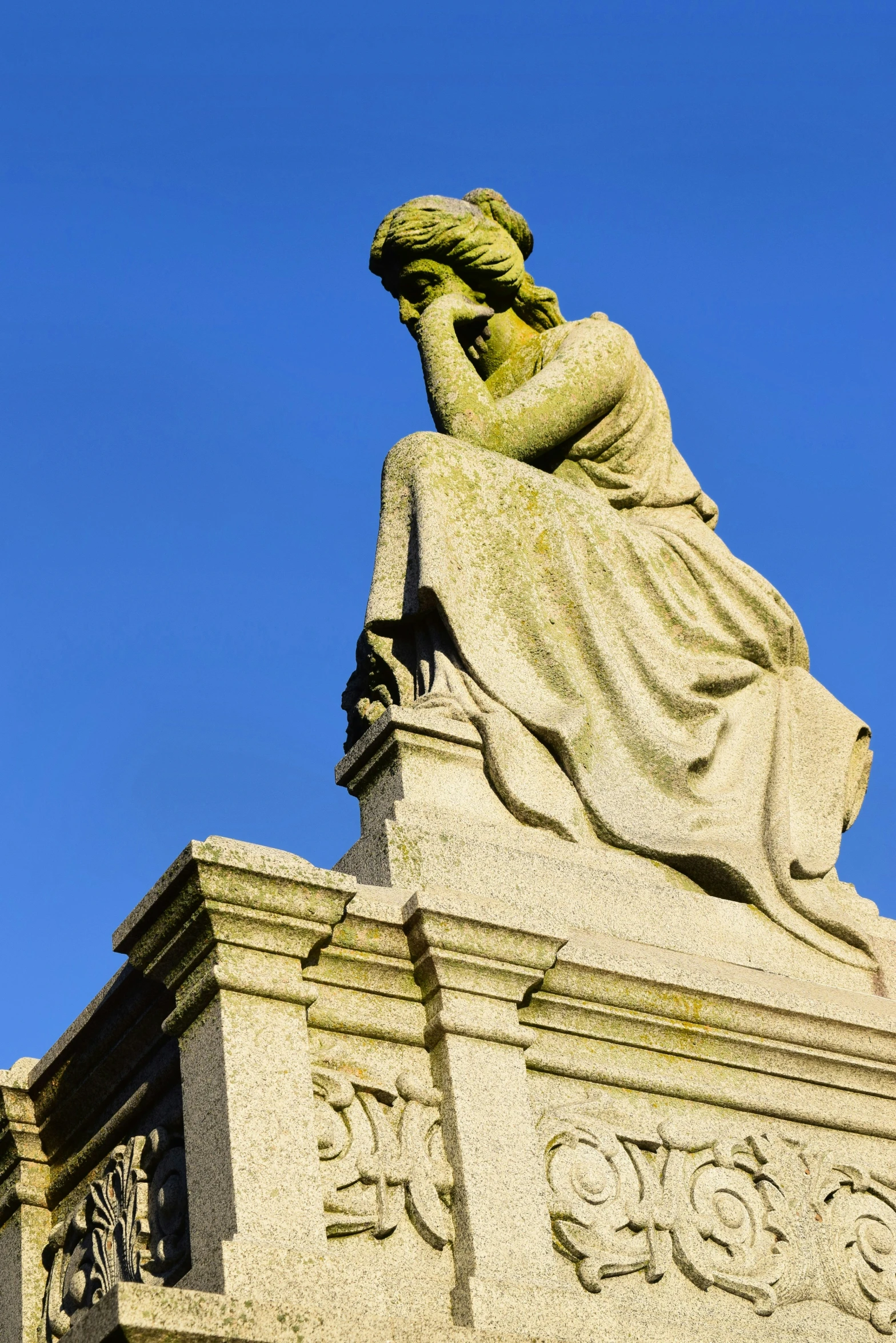 the statue is looking up at the sky