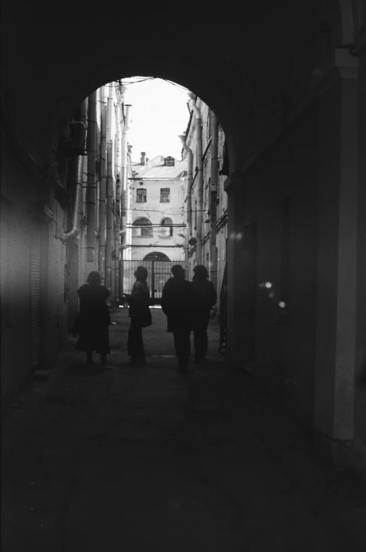 two people walking down a tunnel into the light