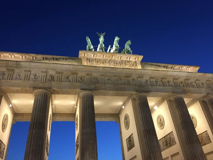 a large stone arch with statues on top