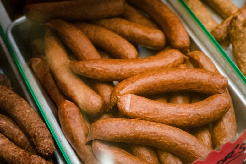 trays filled with sausages and other foods on display