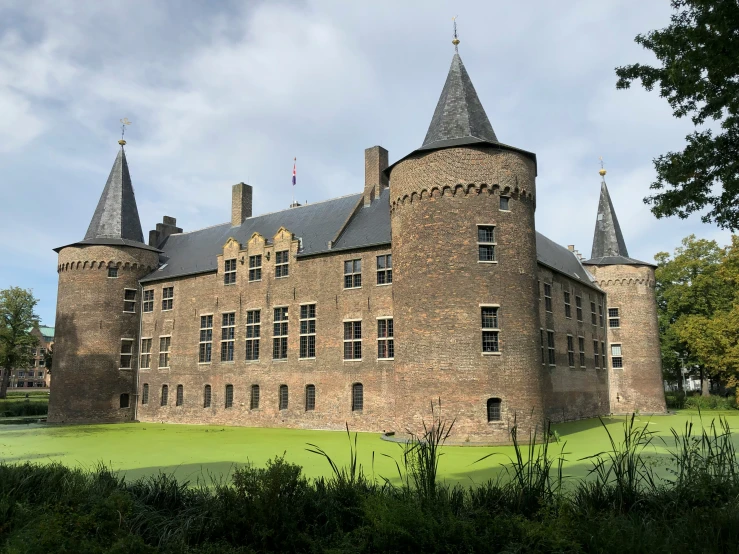 an old brick castle building in an open field