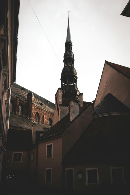 the top of a building in the city with some buildings near by