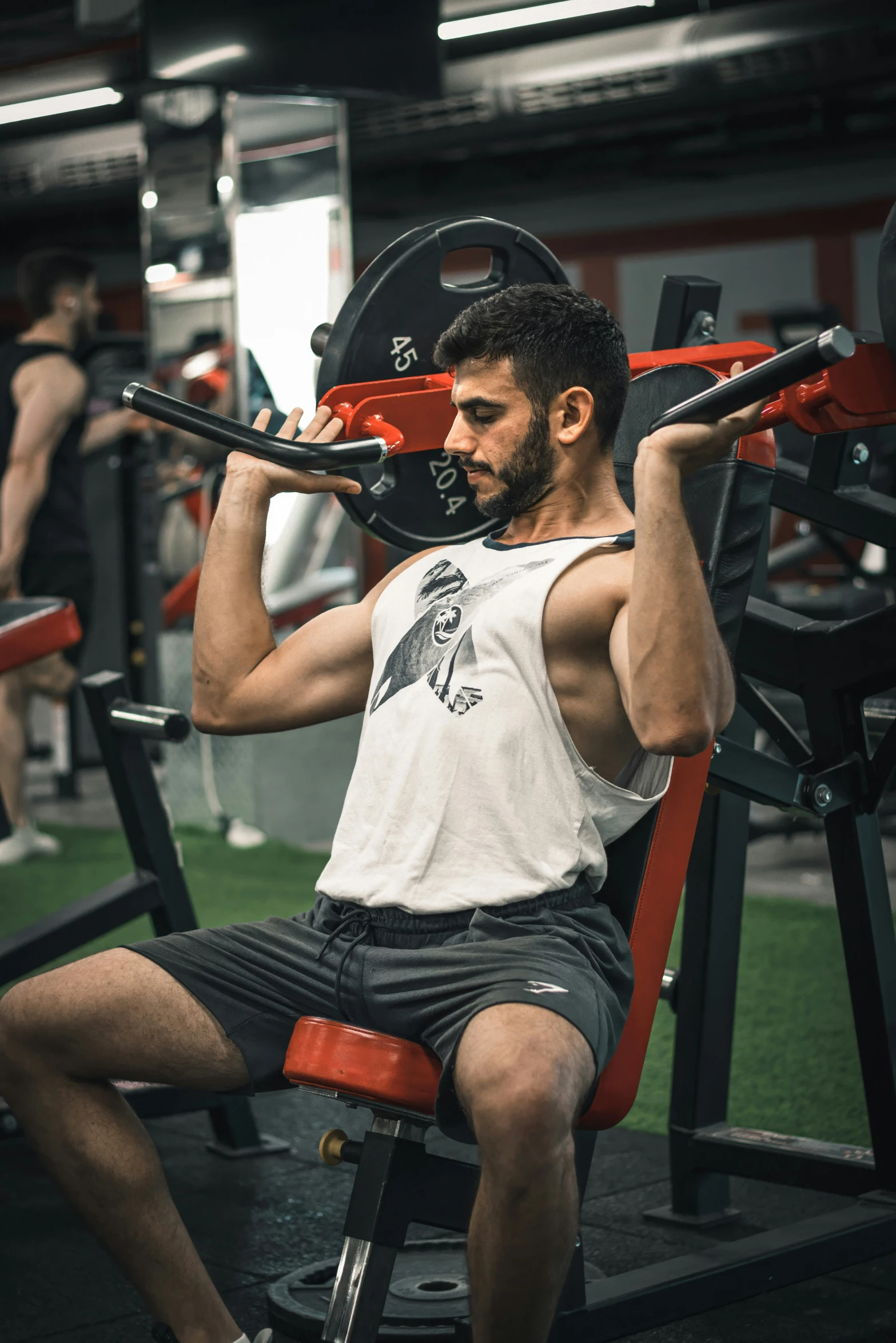 man in gym working out with bench press