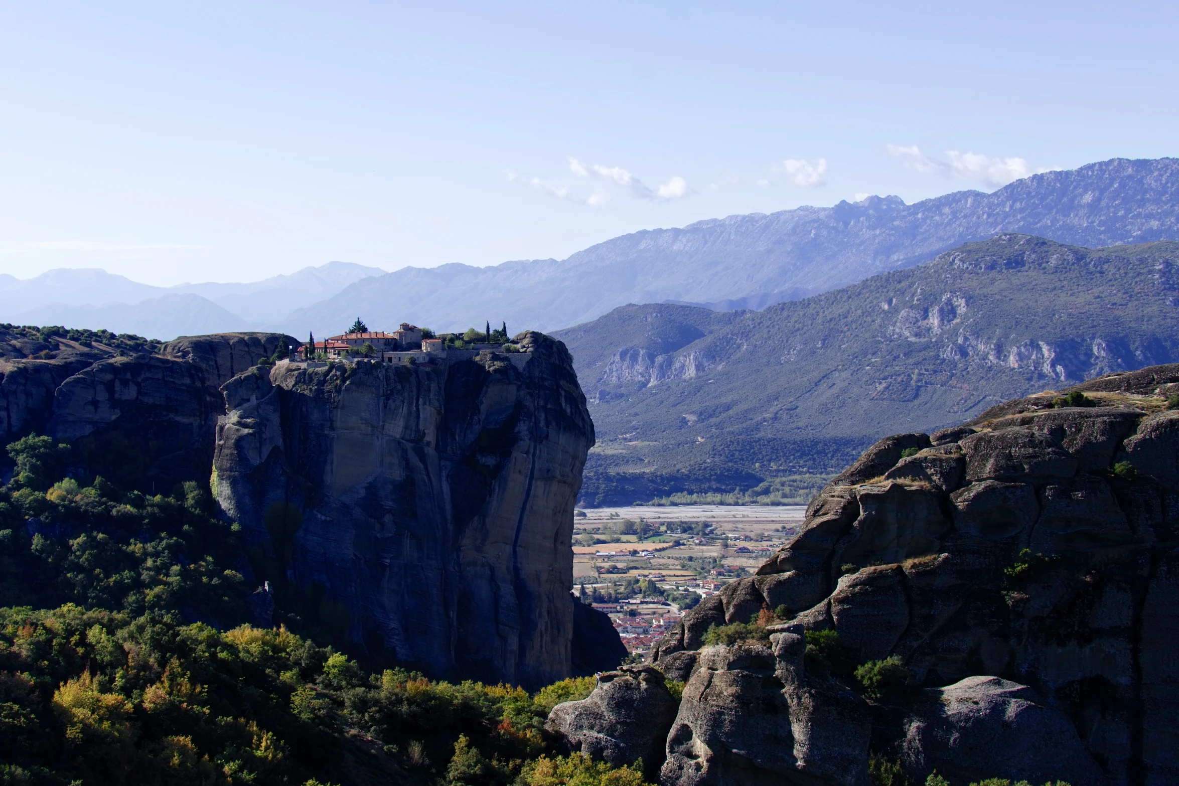 large mountains with mountains in the background and a large rock mountain at the far end