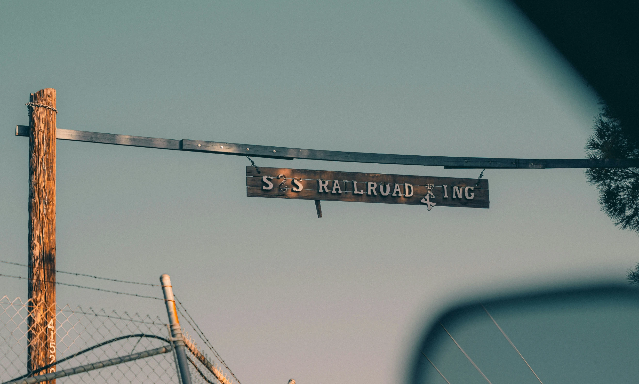 a street sign hanging from a wire that has no cars or traffic on it