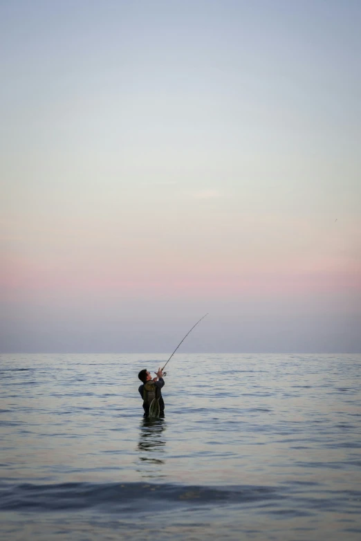 someone fishing from the ocean in the clear day