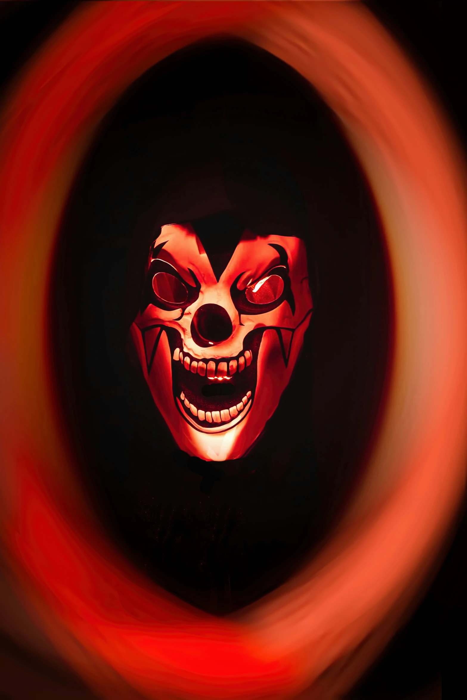 a clown mask is seen through a hole