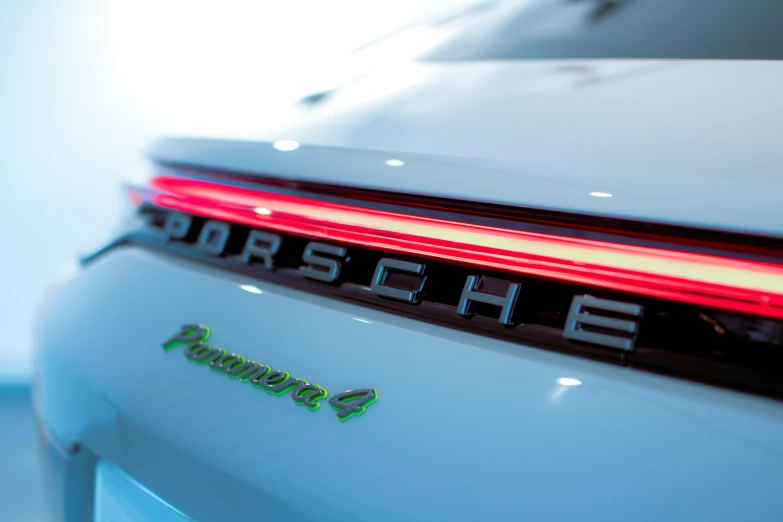 a porsche logo on the tail lights of a vehicle