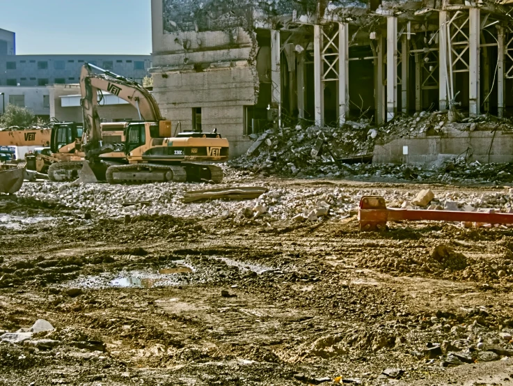 a building being demolished with construction equipment around it