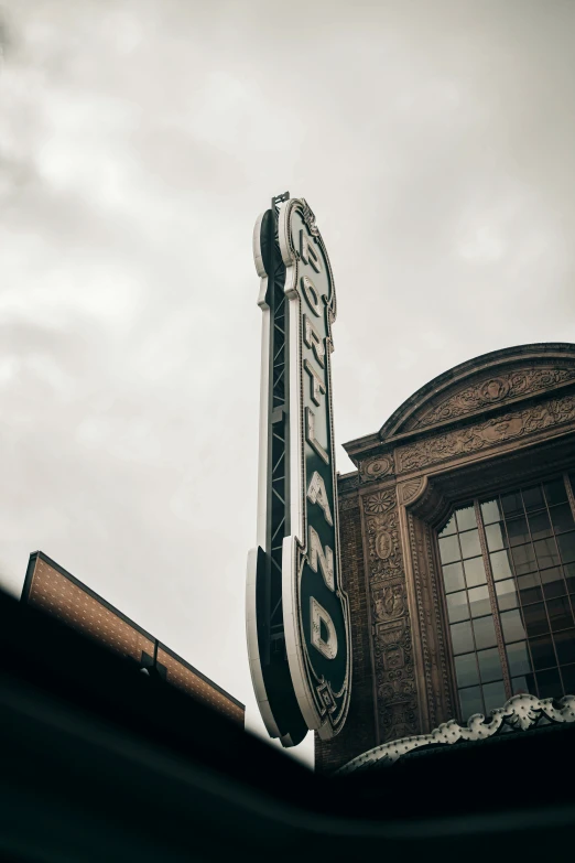 an old theatre sign with a clock and word on it