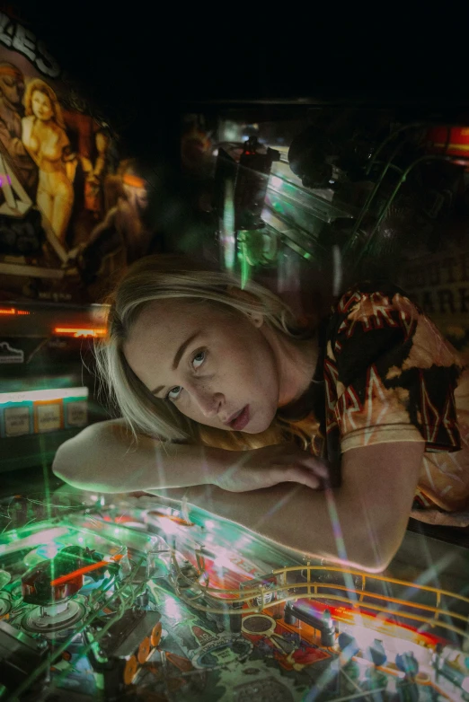 a woman with blond hair standing on top of a carnival ride