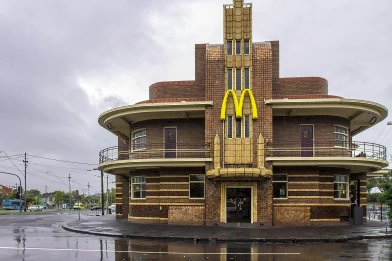 a mcdonalds restaurant sitting on the corner of a road