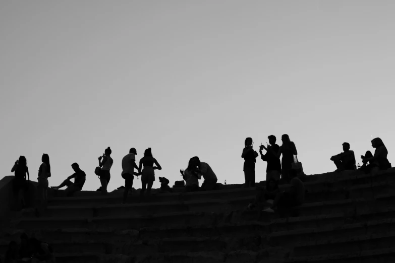 a flock of birds perched on the top of an old theater