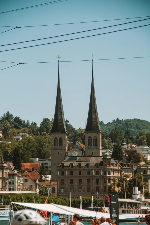 a town with two towers with sails at the end of the river