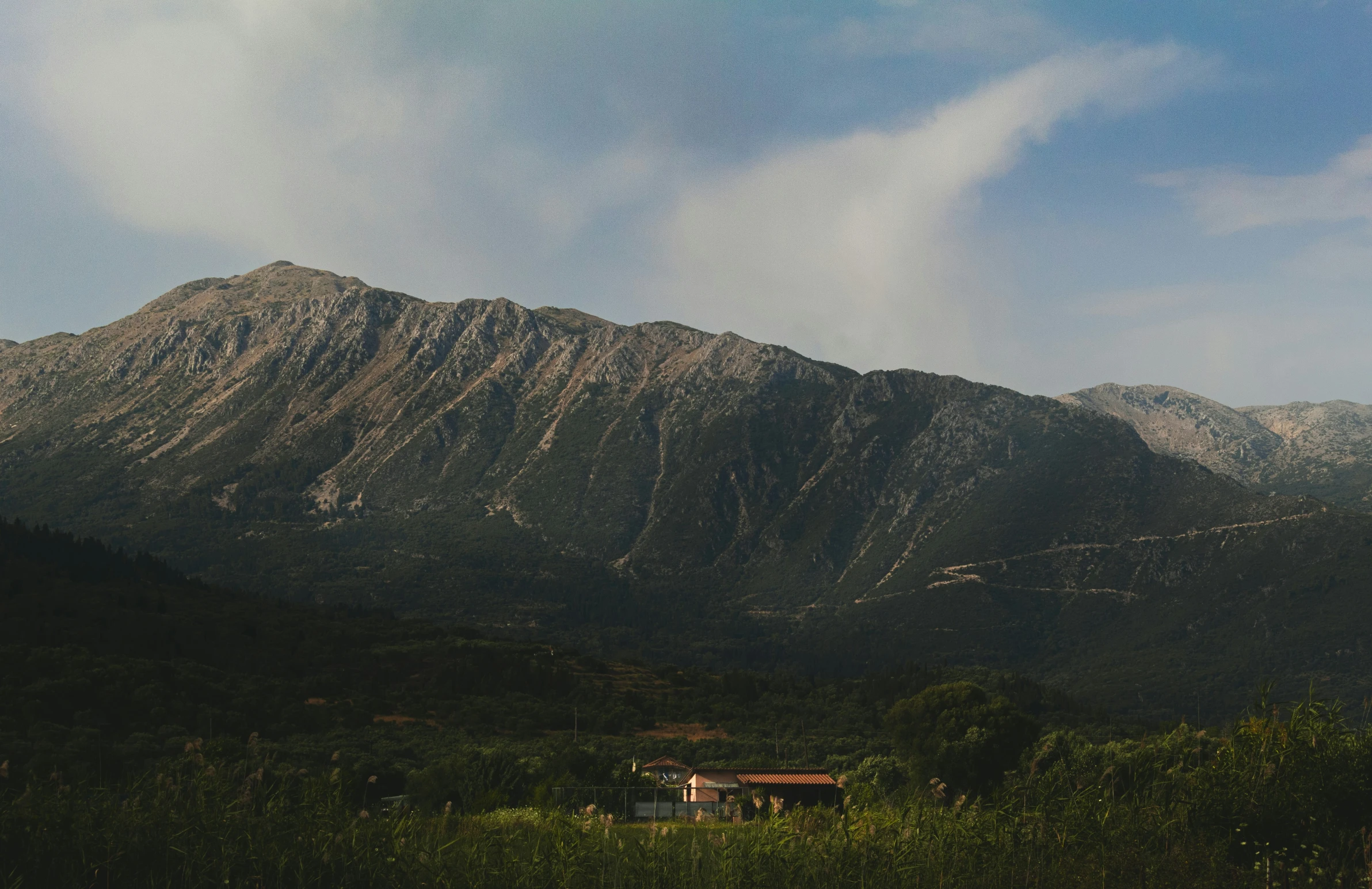 the tops of mountains in a landscape with blue skies