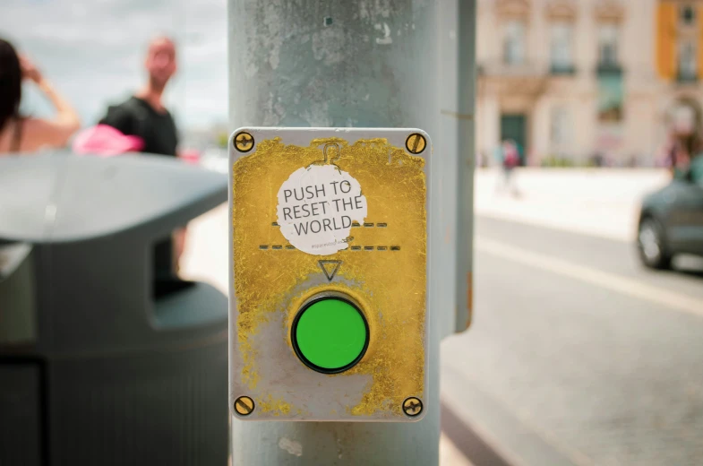 a yellow and white light on a pole with a green light on