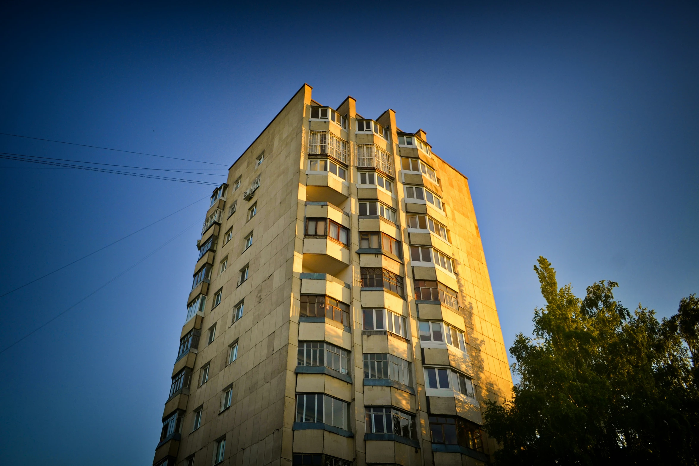 a yellow apartment building on a sunny day