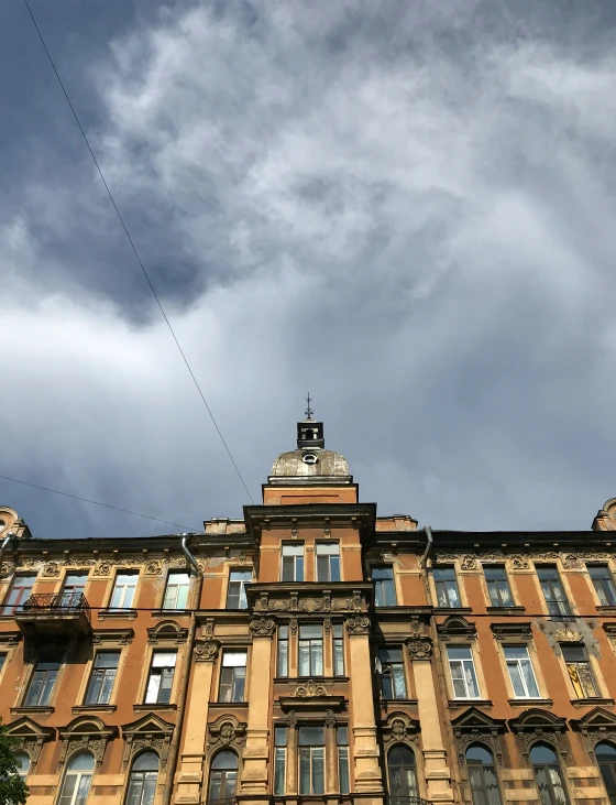 the corner of a tall building with many windows