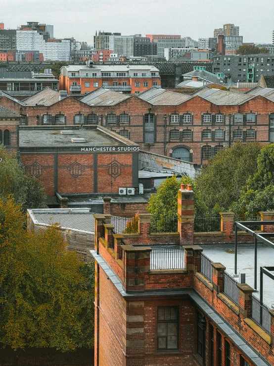 a very tall brick building near some green trees